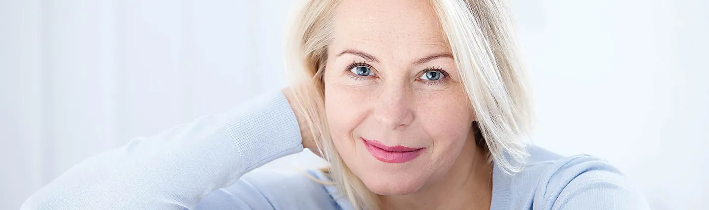 A smiling woman with clear eyes — banner photo from the Insight Eye Center cataract surgery page