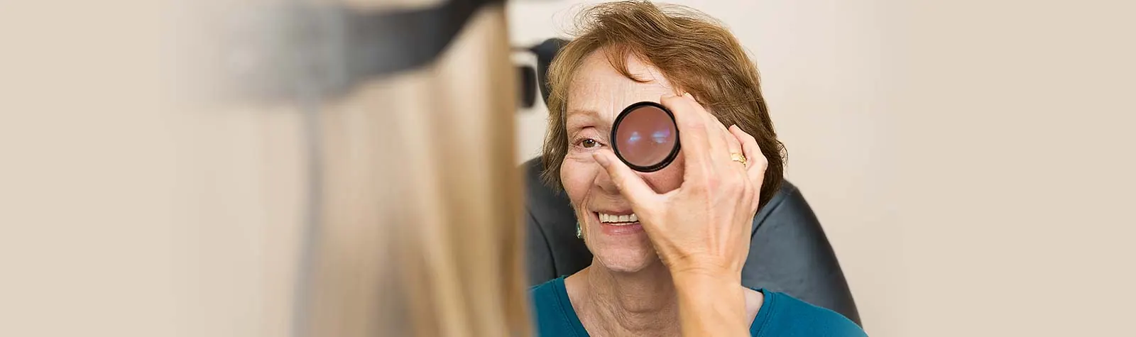 A woman covering one eye with an occluder during a vision test — banner photo from the current diabetic retinopathy page