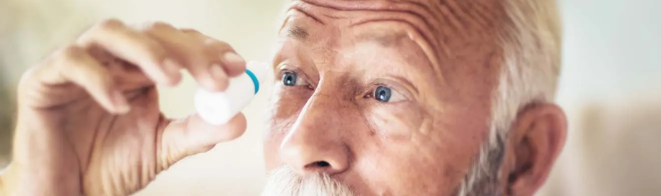 An older man putting in eye drops — banner photo from the current glaucoma treatment page