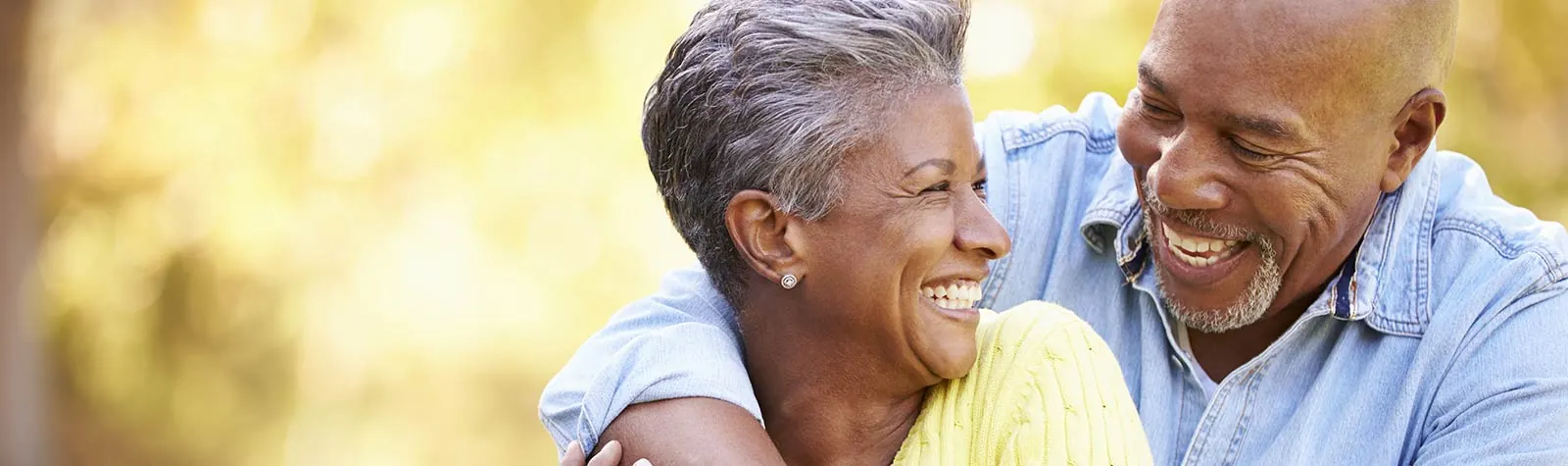 A smiling older couple outdoors — the photo from the practice's patient reviews page