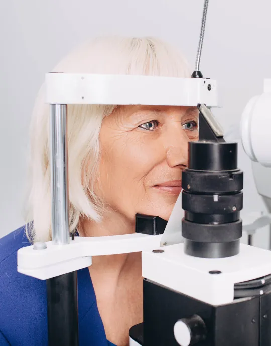 A patient being examined at the slit lamp before cataract surgery