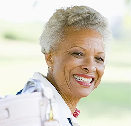 A smiling woman in her seventies with short gray hair