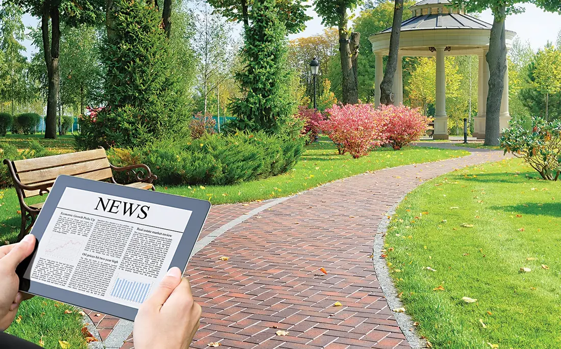 A brick path through a park with a bench and a gazebo, shown as a clearer view on the right and with an illustration of cataract-related blur, glare and yellowing on the left