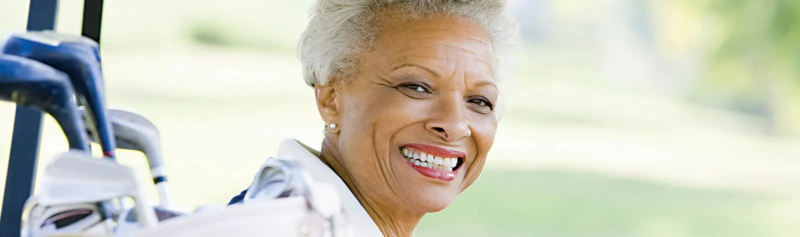 A smiling woman with gray hair — banner photo from the current YAG laser page